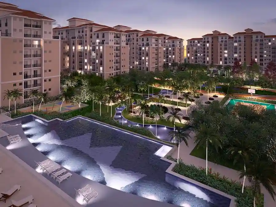 Render de condomínio com piscinas iluminadas à noite