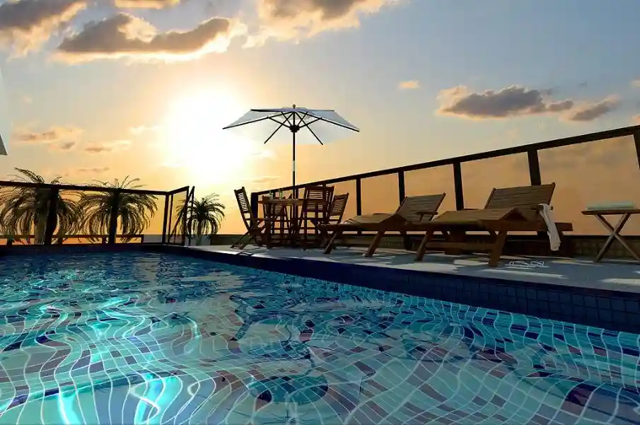 Render de piscina na cobertura ao pôr do sol